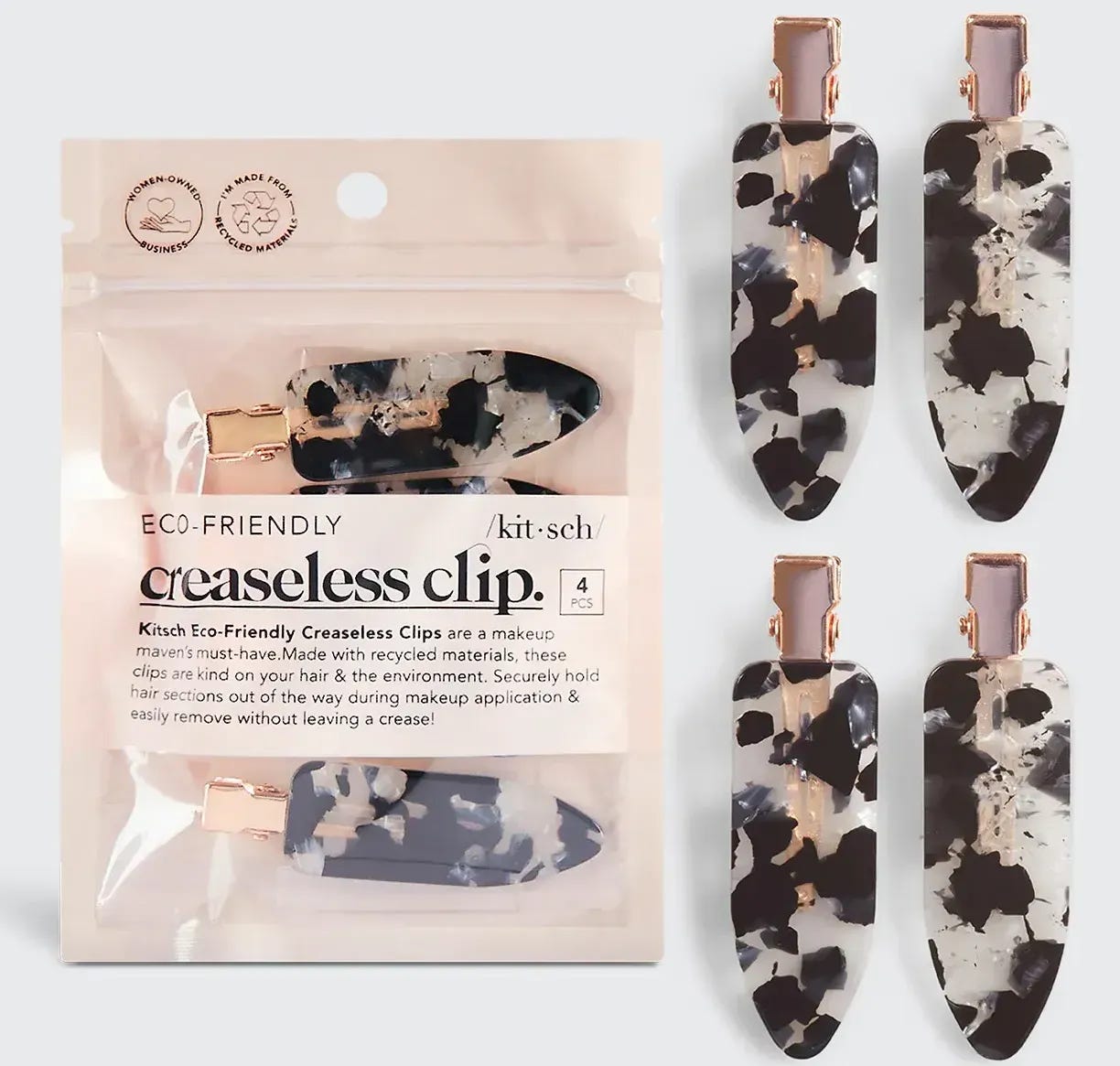 Kitsch Creaseless Hair Clips in a black terrazzo pattern displayed with their product packaging. Kitsch Creaseless Hair Clips in a black terrazzo pattern displayed with their product packaging.