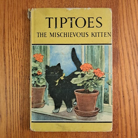 six childhood books set against wood or dark cloth