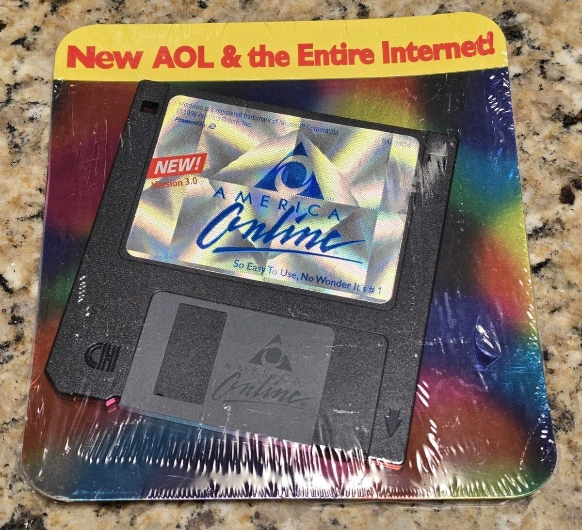 An AOL floppy disc shrink-wrapped on a square piece of card. The disc offers AOL internet service