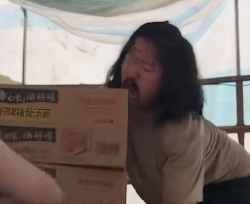 Hu gets out of his wheelchair and helps pack and stack boxes of supplies for victims. Photo: handout Hu gets out of his wheelchair and helps pack and stack boxes of supplies for victims. Photo: handout