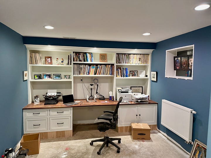 Two photos showing an in-progress basement renovation with built-in entertainment center and desk.