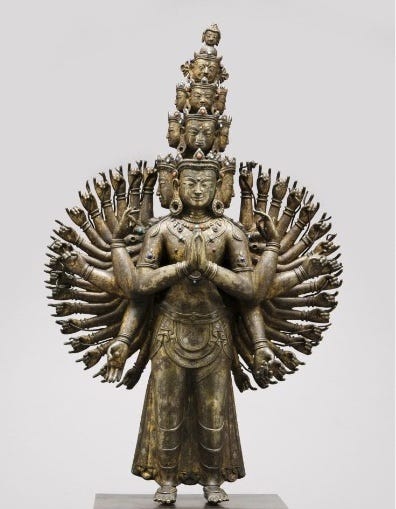 statue of figure with many arms and many heads