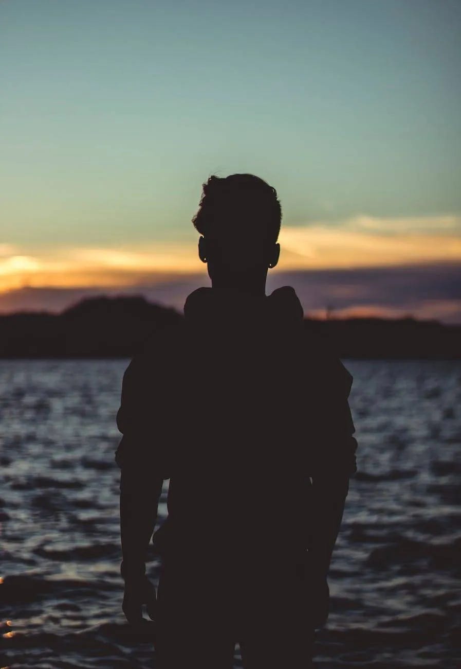 silhouette photo of person near body of water silhouette photo of person near body of water