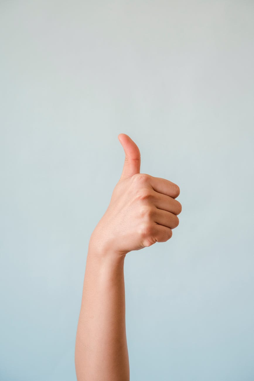 a person doing the thumbs up sign