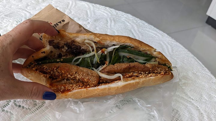 banh mi held in hand, and one opened up