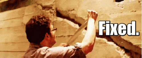 Man putting a piece of tape over a massive crack in wall