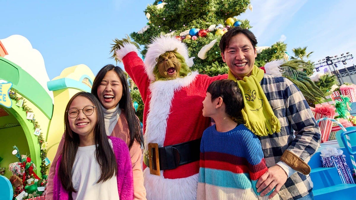 The Grinch meets a family during Grinchmas at Universal Studios Hollywood. Image: Universal Studios Hollywood The Grinch meets a family during Grinchmas at Universal Studios Hollywood. Image: Universal Studios Hollywood