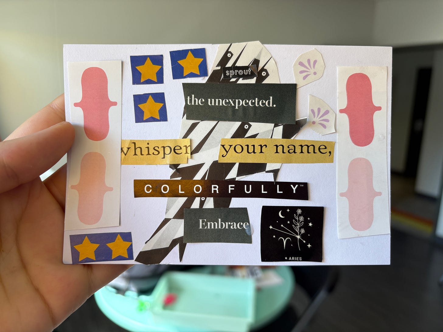 Collaged poem with magazine cutouts on a blank white postcard. It is being held by Shady with just their fingers visible. Collaged poem with magazine cutouts on a blank white postcard. It is being held by Shady with just their fingers visible.
