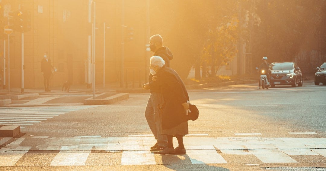 a person crossing a street at a crosswalk a person crossing a street at a crosswalk