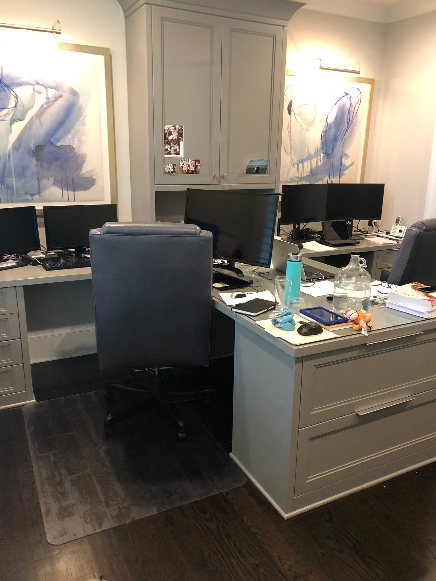 A home office set up with two workstations side by side, showing two full-time jobs run from one room. 