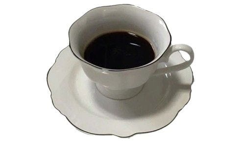 This may contain: a cup of coffee sitting on top of a white saucer with black liquid in it