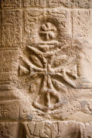 Christian cross carved into Egyptian hieroglyphics at Temple of Isis at Philae, in southern Egypt