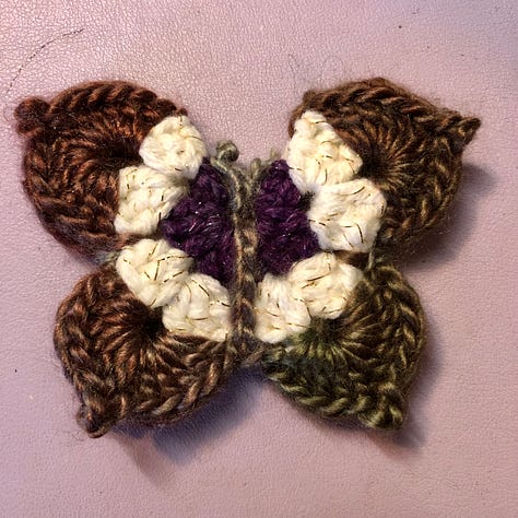 Nine multi-coloured crocheted butterflies
