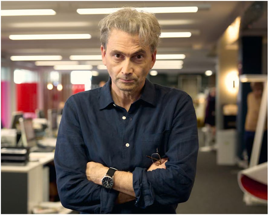 A person with his arms crossed

Description automatically generated