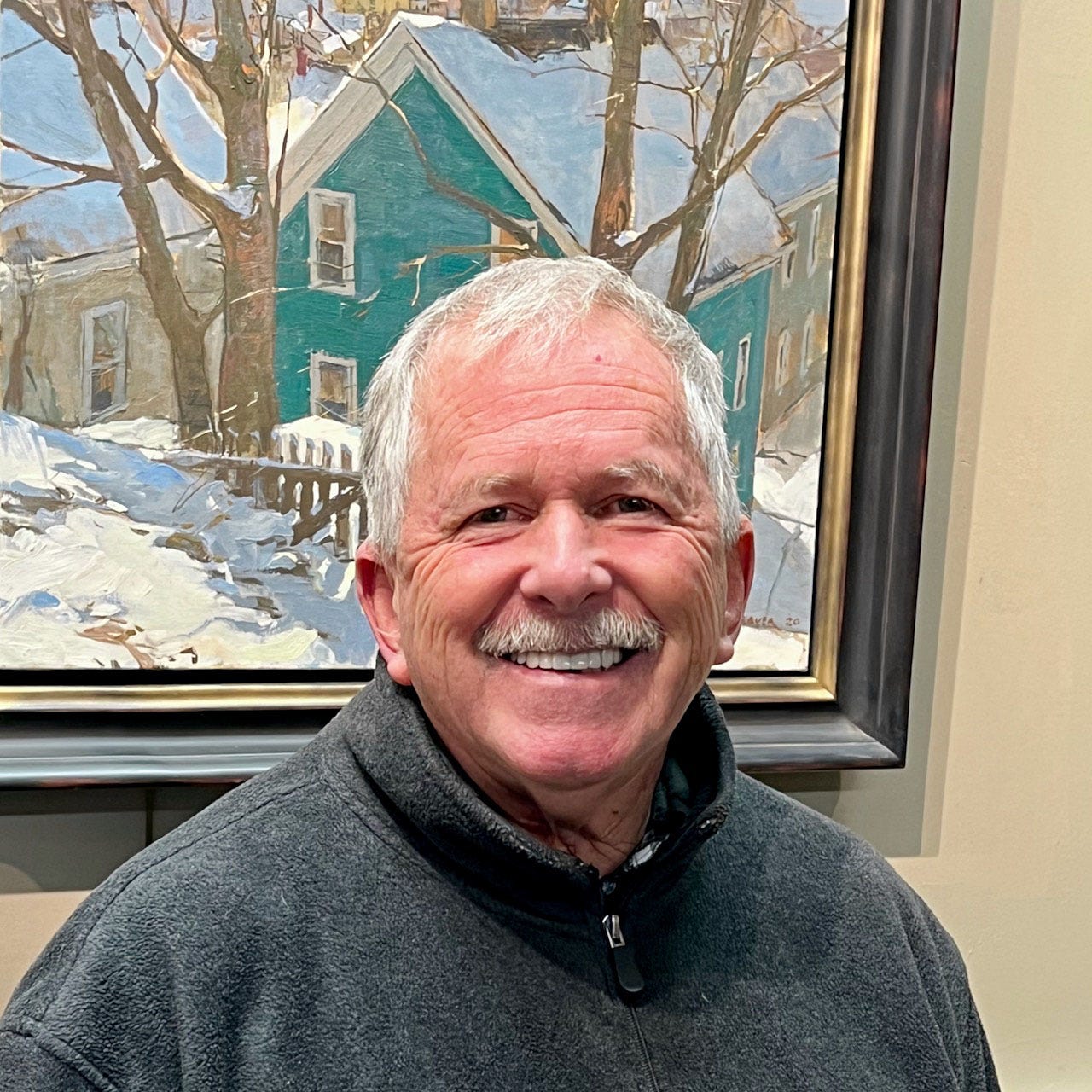 A person smiling in front of a framed picture

Description automatically generated with medium confidence