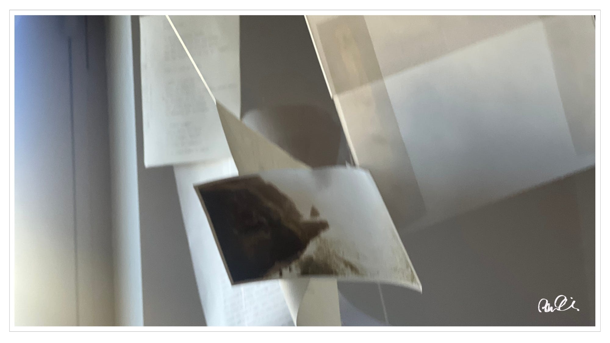 Sand-colored paper notes and cards, hanging from string