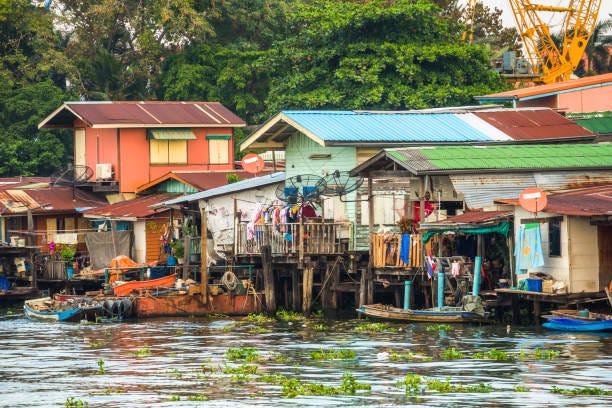 Stilt Houses on Chao Phraya Riverbank in Bangkok, Thailand Stilt Houses at a Klong in Bangkok, Thailand. Chao Phraya Riverbank with Lush Vegetation. riverside house at chao phraya river in bangkok thailand stock pictures, royalty-free photos & images Stilt Houses on Chao Phraya Riverbank in Bangkok, Thailand Stilt Houses at a Klong in Bangkok, Thailand. Chao Phraya Riverbank with Lush Vegetation. riverside house at chao phraya river in bangkok thailand stock pictures, royalty-free photos & images
