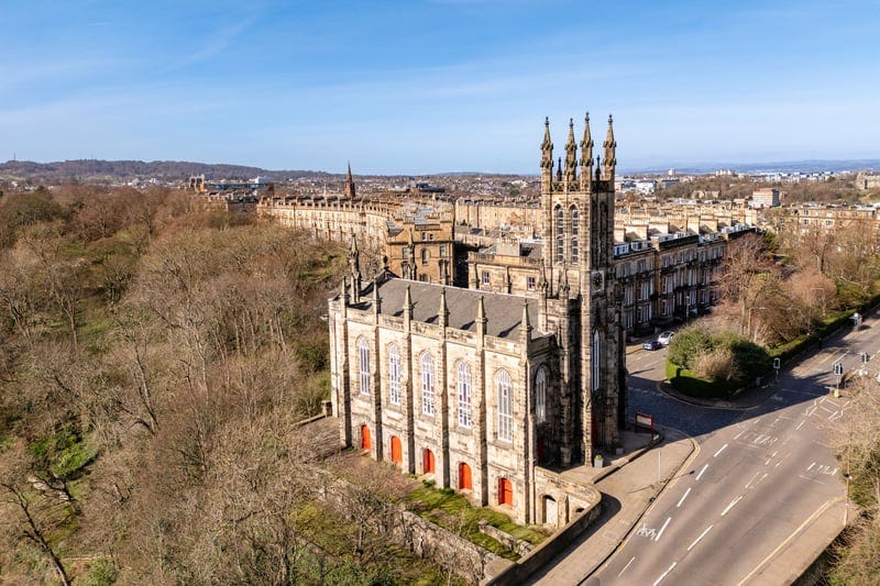 Drone image showing the church's gothic structure and prominent location on Dean Bridge