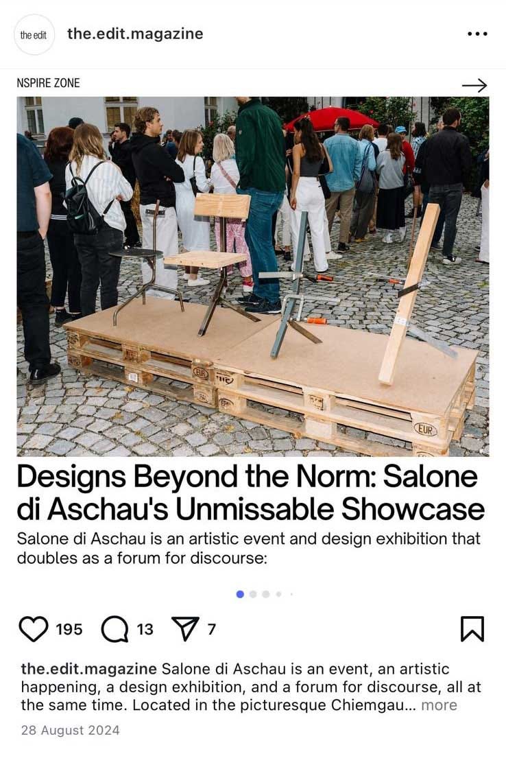 This image is a screenshot of a social media post from "the.edit.magazine." It features a photograph of an outdoor art or design exhibition, with people gathered around a display made of wooden pallets holding what appears to be furniture or artistic installations. The post is titled "Designs Beyond the Norm: Salone di Aschau's Unmissable Showcase" and describes the event as an artistic event and design exhibition in Chiemgau. This image is a screenshot of a social media post from "the.edit.magazine." It features a photograph of an outdoor art or design exhibition, with people gathered around a display made of wooden pallets holding what appears to be furniture or artistic installations. The post is titled "Designs Beyond the Norm: Salone di Aschau's Unmissable Showcase" and describes the event as an artistic event and design exhibition in Chiemgau.