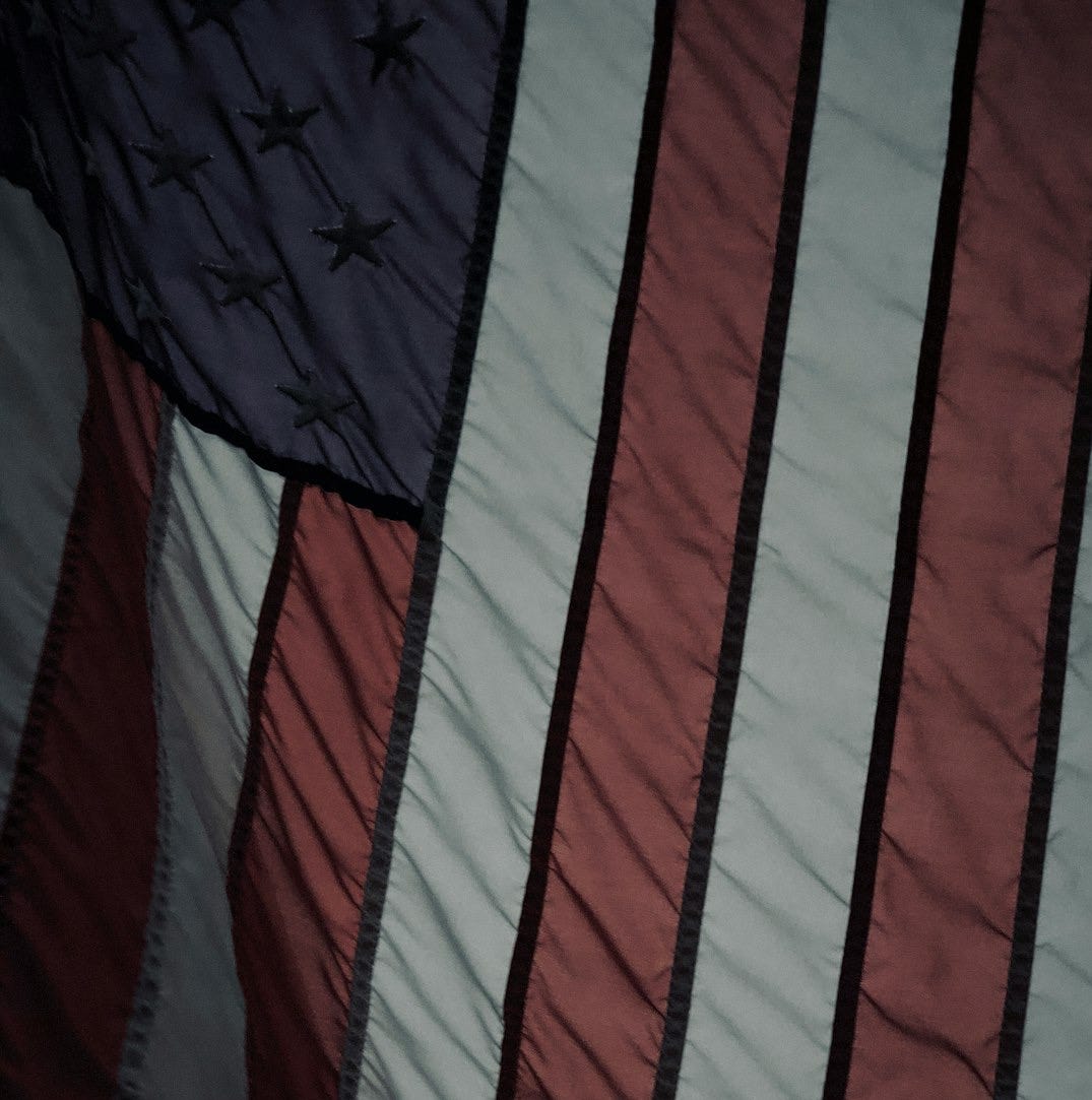 a close up of an american flag on a bed a close up of an american flag on a bed