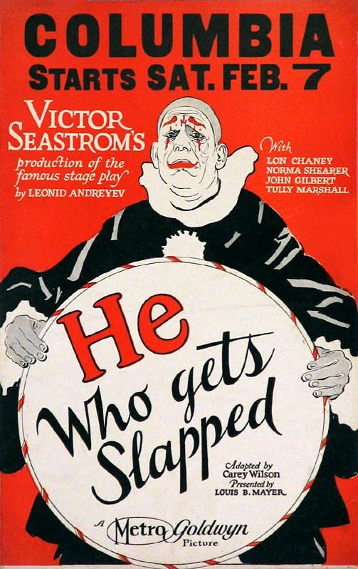 Movie poster for He Who Gets Slapped. The titular clown is holding a circular sign with the movie title. Cast and crew credits are visible surrounding him. Movie poster for He Who Gets Slapped. The titular clown is holding a circular sign with the movie title. Cast and crew credits are visible surrounding him.