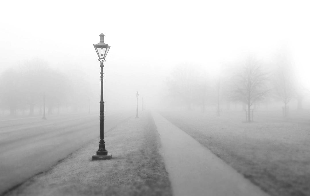 grayscale photo of street post with smoke grayscale photo of street post with smoke