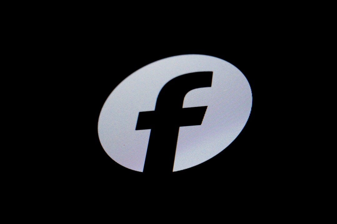 A silver 'f' logo on a black background A silver 'f' logo on a black background