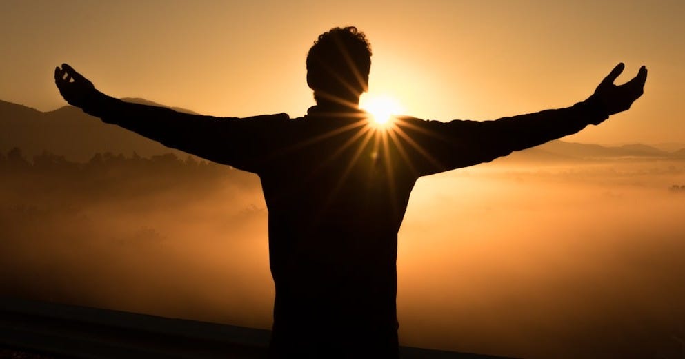 silhouette photo of man on cliff during sunset silhouette photo of man on cliff during sunset