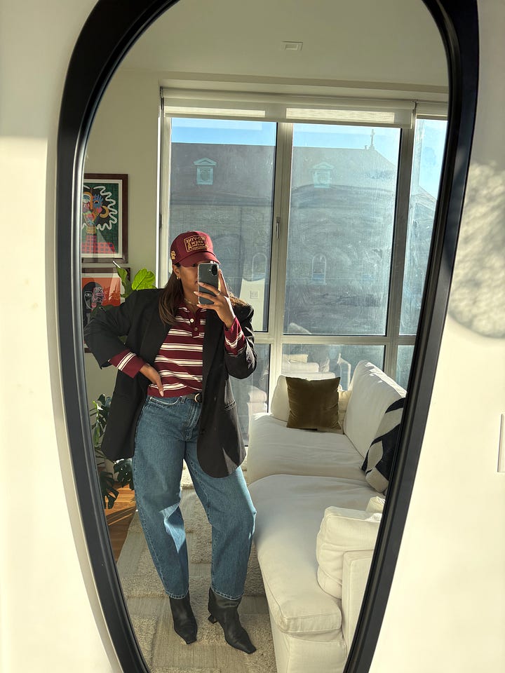 Two full-bodied mirror selfie photos side by side with a Black woman posing in two fun and casual outfits that feature layered pieces and statement hats.