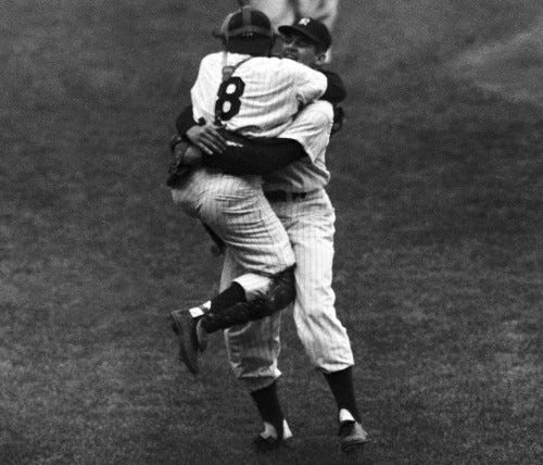 New York Yankees' catcher Yogi Berra leaps into the arms of pitcher Don Larsen after Larsen struck out the last Brooklyn Dodgers' batter to complete his perfect game during the fifth game of the World Series, Oct. 8, 1956. Racing up in the background is Joe Collins. (AP Photo) New York Yankees' catcher Yogi Berra leaps into the arms of pitcher Don Larsen after Larsen struck out the last Brooklyn Dodgers' batter to complete his perfect game during the fifth game of the World Series, Oct. 8, 1956. Racing up in the background is Joe Collins. (AP Photo)