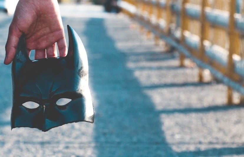 person holding green and white mask