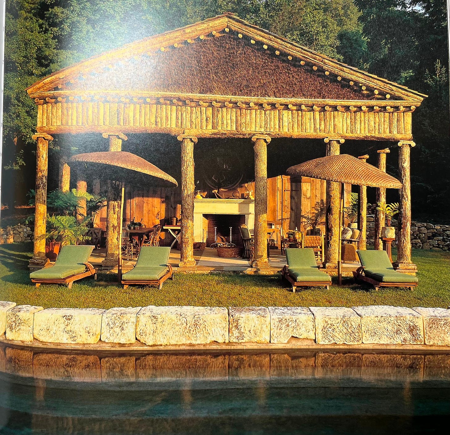 Photo of an elegant pool house made of raw logs, with 4 green sun lounges in front. Photo of an elegant pool house made of raw logs, with 4 green sun lounges in front.