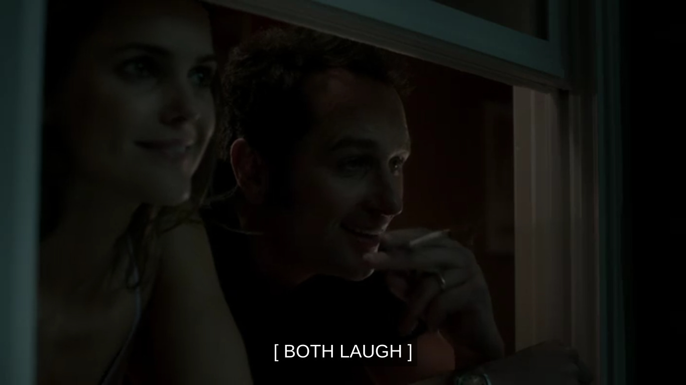 Elizabeth and Philip leaning out a window, Philip holding a joint