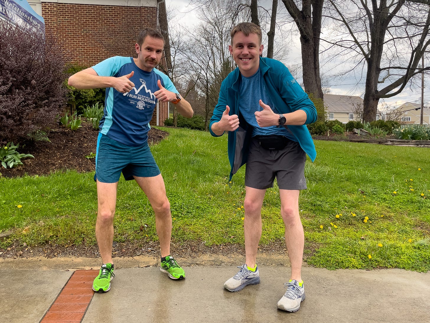 Two runners looking at a camera, giving a thumbs-up. Two runners looking at a camera, giving a thumbs-up.