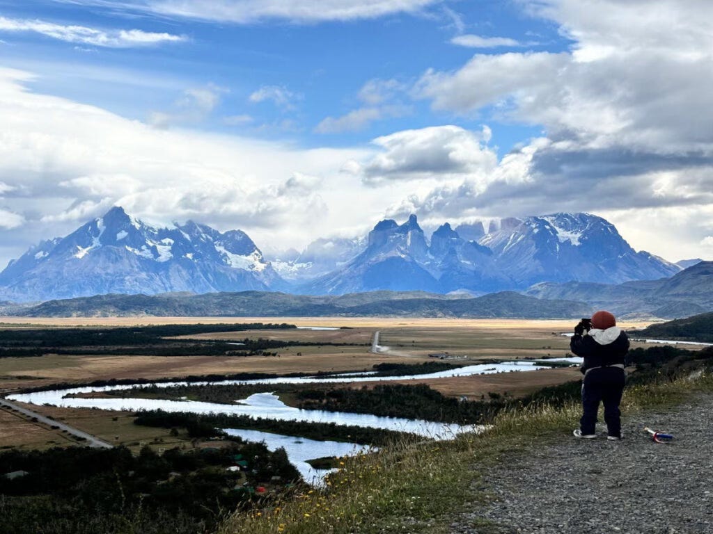 Joan taking a photo of the mountains in Patagonia