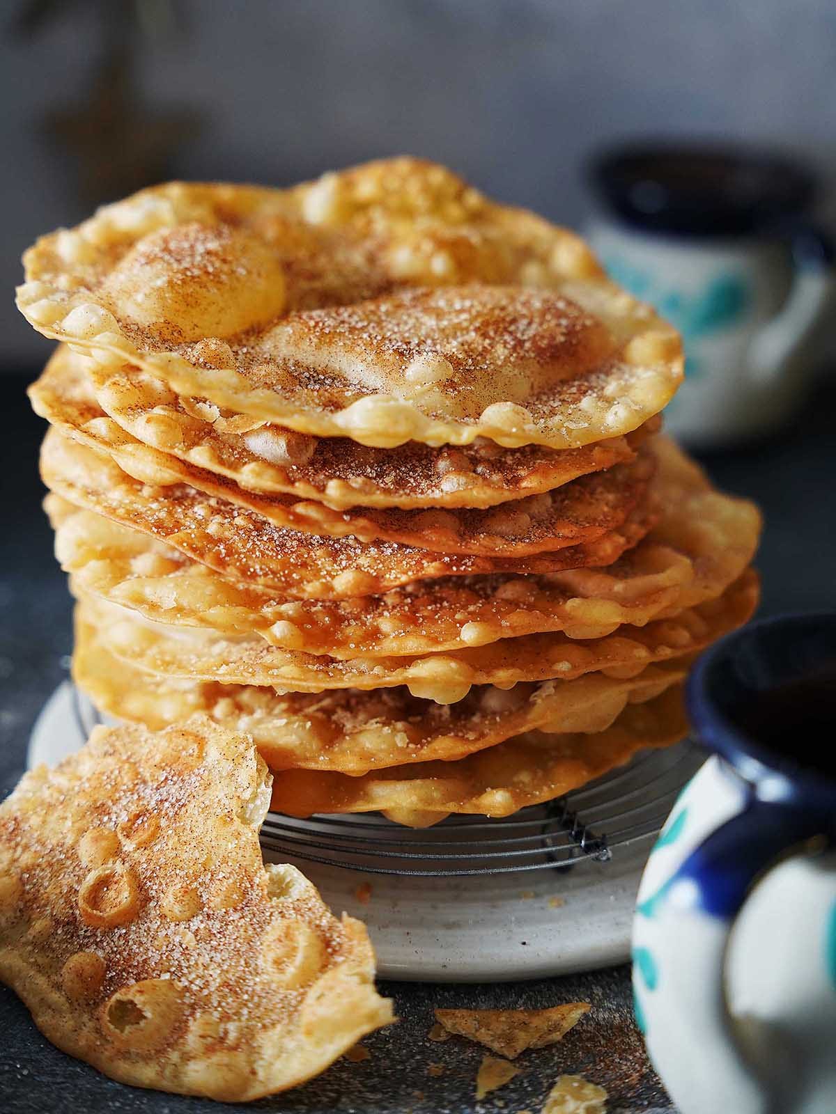 A stack of buñuelos on a white plate.