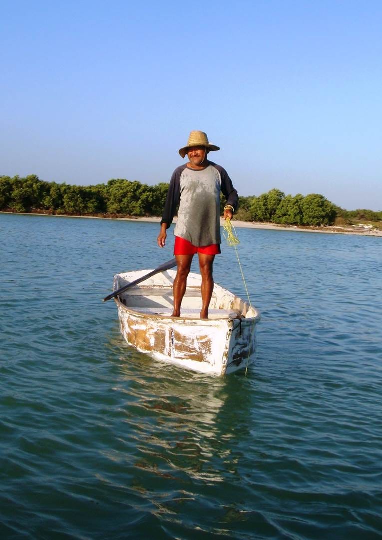 A person standing on a boat in water

Description automatically generated