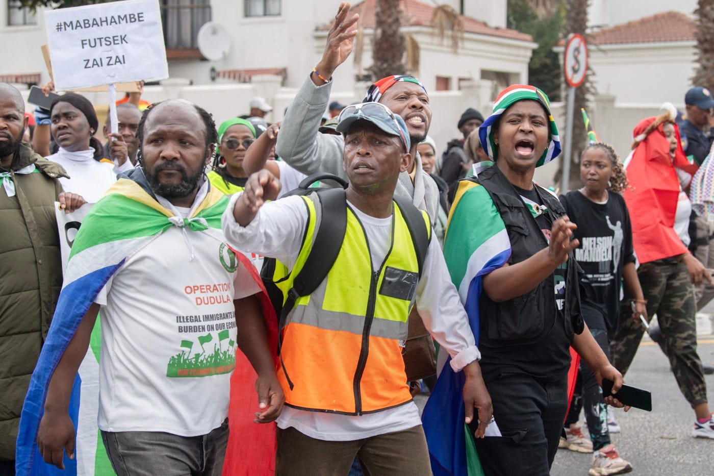 A group of about 80 people, some carrying banners and waving South African flags, take part in a march organised by March and March as they protest against undocumented migrants in Parklands, a suburb of Cape Town, on June 27, 2026. AFP A group of about 80 people, some carrying banners and waving South African flags, take part in a march organised by March and March as they protest against undocumented migrants in Parklands, a suburb of Cape Town, on June 27, 2026. AFP