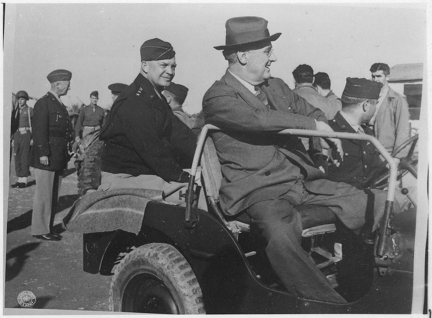 US President Franklin D. Roosevelt with legendary Generals Dwight Eisenhower and George S. Patton (in background) in 1943, planning WWII strategy.