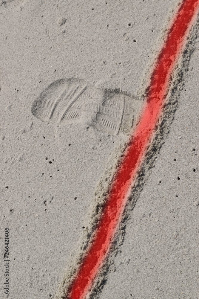 crossing a red line in the sand Stock Photo | Adobe Stock