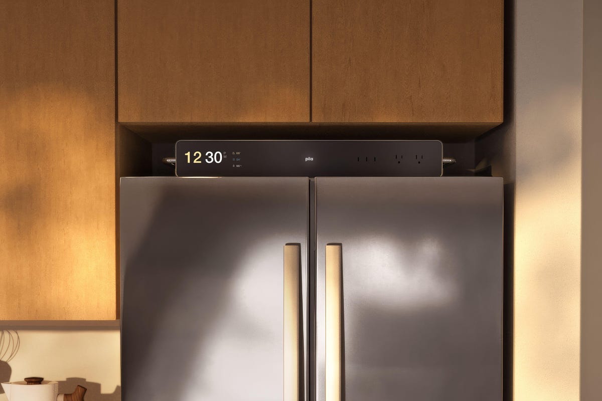 A rendering of a slim battery on top of a refrigerator.