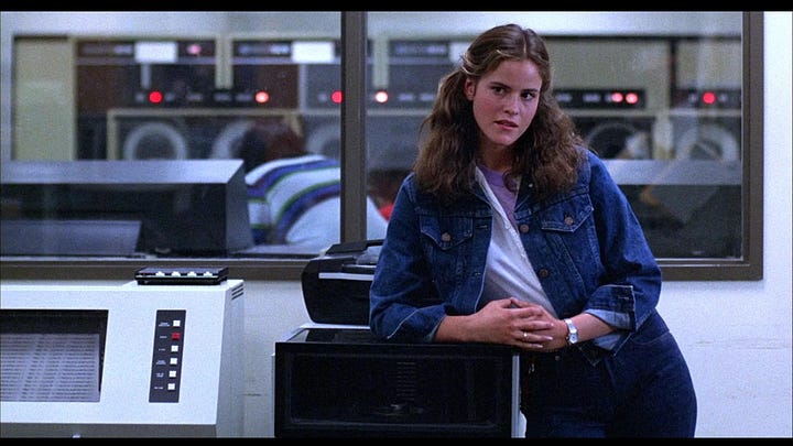 a side by side screen shot of Ally Sheedy from the movie War Games leaning on a desk in a computer lab