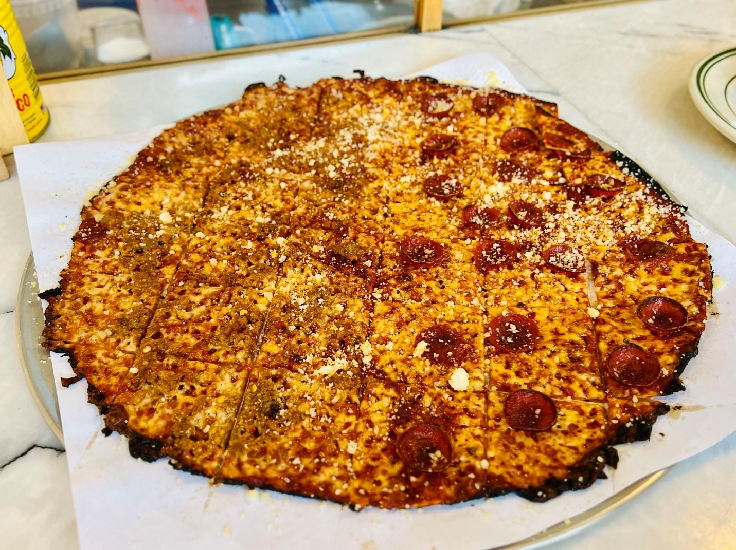 A pizza on a plate

Description automatically generated