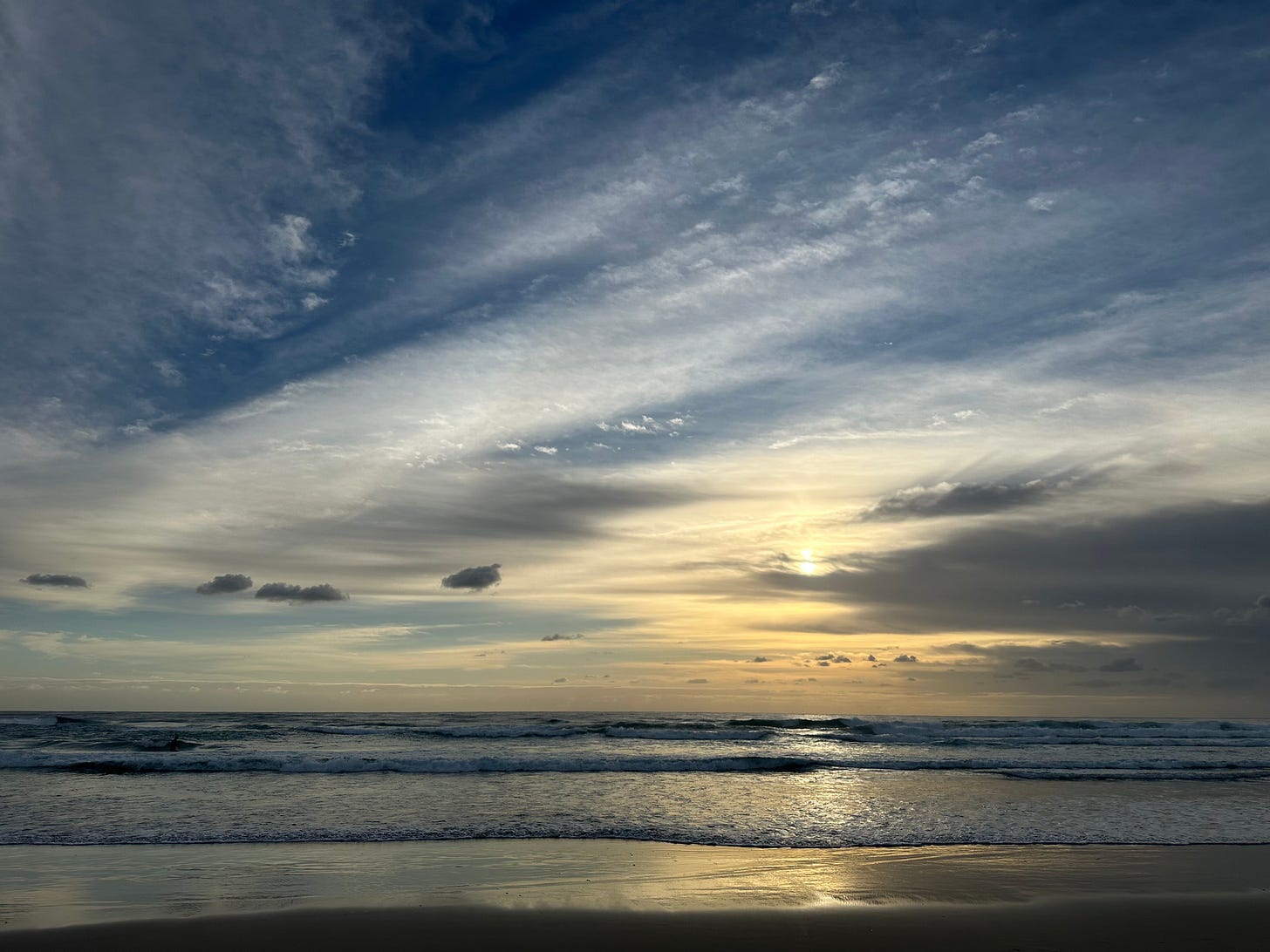 A photo looking out across a beach while the tide comes in.