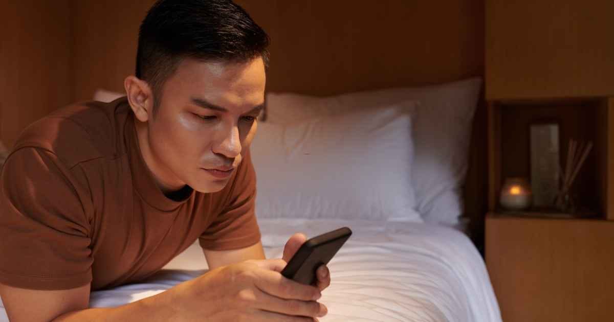 young man looking at his phone