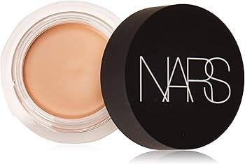 Product shot of the Nars Soft Matte Complete Concealer. It is shown in its small, round black jar, highlighting its dense, high-pigment cream formula suitable for targeted spot concealment.
