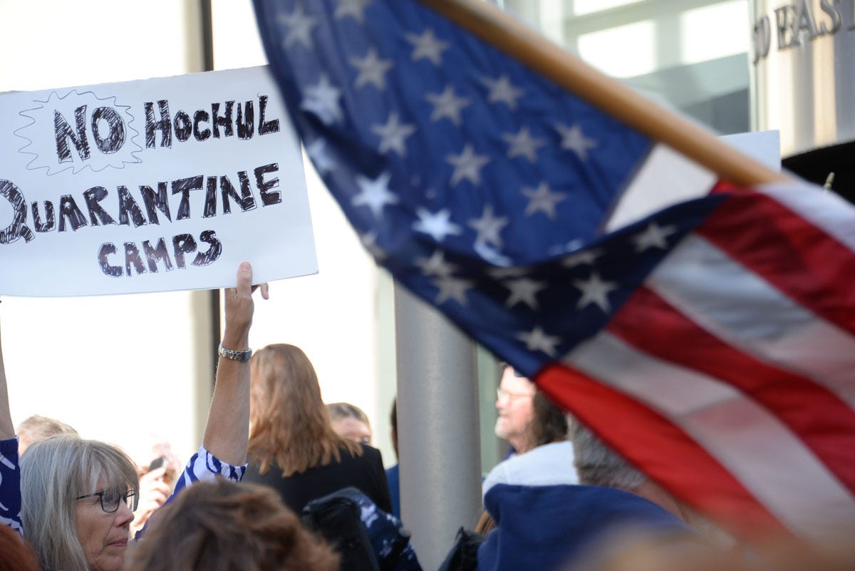 Woman Holding Sign: No Hochul Quarantine Camps Woman Holding Sign: No Hochul Quarantine Camps