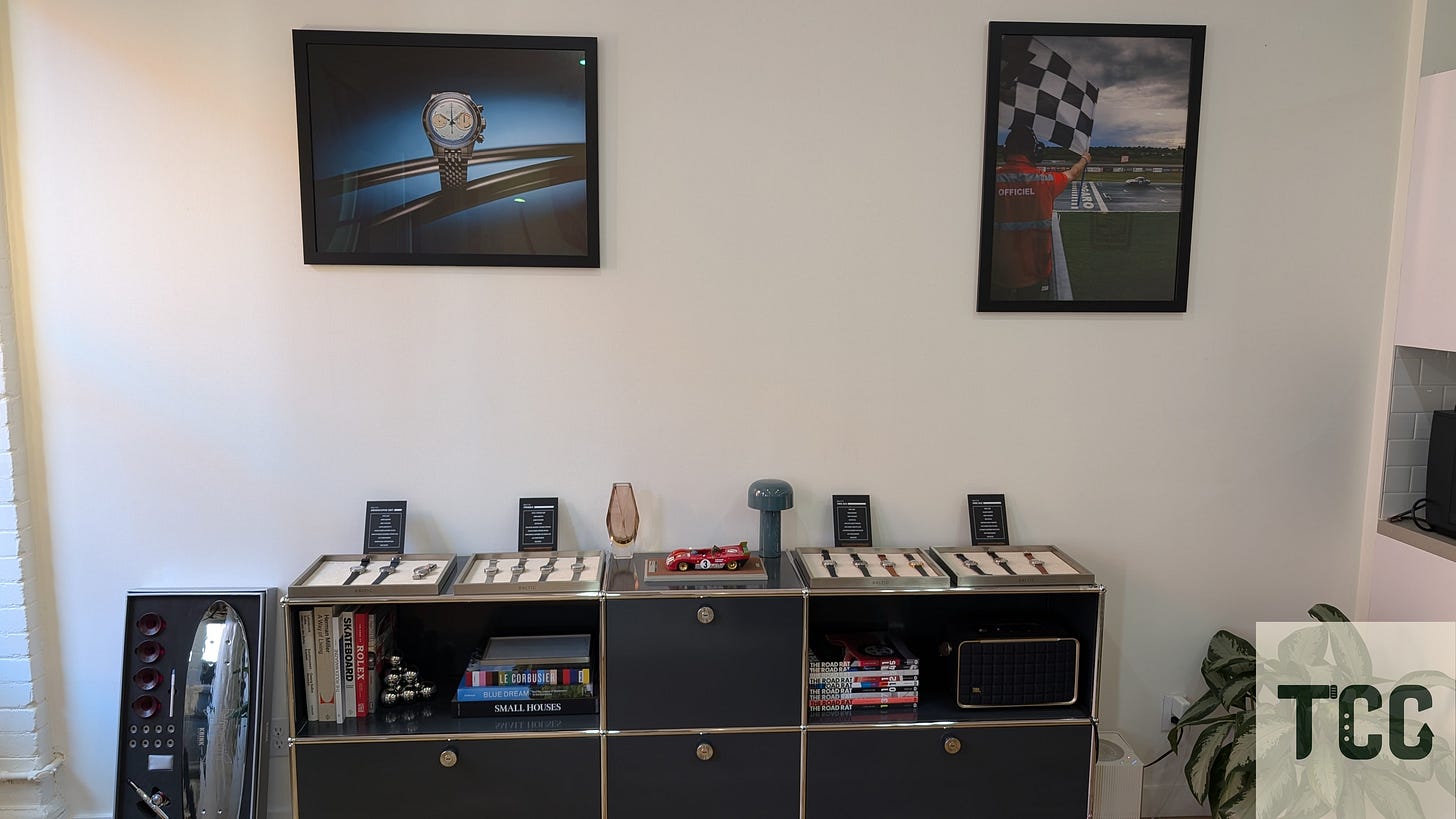 More Baltic watches on display with books and other designer items below and nearby.