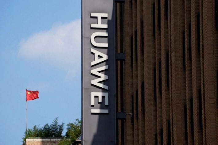 A Chinese flag flutters near a Huawei store in Shanghai, China