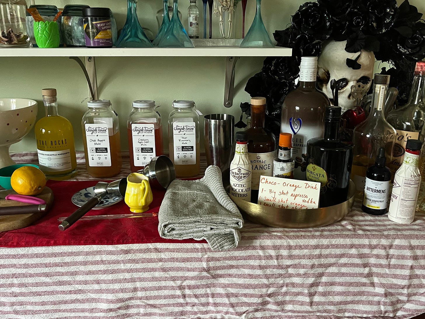 Messy Halloween bar with some simple time mixers (not an ad!) and my cocktail I made up, above)